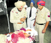 Police officials record the statement of Harbans Kaur, who was allegedly attacked by her husband, at the Civil Hospital in Jagraon on Monday