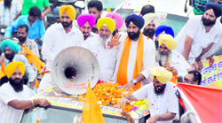 Youth Akali Dal president Bikram Singh Majithia waves to his supporters during a road show in Ludhiana on Monday
