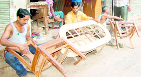Carpenters prepare furniture in Amritsar.