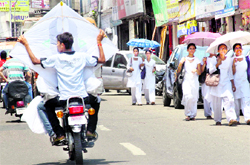 A boy carries a kite on a motorcycle in Jammu on Tuesday
