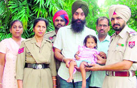 The rescued 10-month-old girl being handed over to the volunteers of Talwandi Dham in Ludhiana on Tuesday.