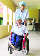 Aalamjot being taken to his class by a classmate at Nankana Sahib Public School.