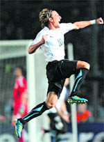 Uruguayan forward Diego Forlan celebrates after they beat Argentina in Copa America quarter-final on July 16. Uruguay will now face Peru in semi-finals