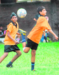 Players of St Kabir School, Sector 26, and Shri Guru Gobind Singh School, Sector 35, vie for the ball during their match in the Pre-Subroto Football (U-14) Cup for Boys at Government Model Senior Secondary School in Sector 22 of Chandigarh on Wednesday. 