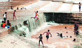 Living life risk-wise Children from a nearby slum take a bath in the Ghaggar at Panchkula on Wednesday.