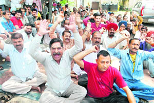 Members of the SRTC Employees Union hold a protest in support of their demands at Bikram Chowk in Jammu on Wednesday.