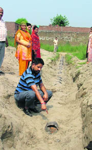 Vinod Sharma, president, Baba Deep Singh Ji Welfare Society, points to the partially-laid sewerage in street No. 6 of Civil City, Ludhiana