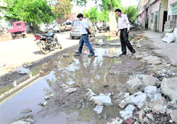 Rainwater accumulates in front of factories at Phase II, Industrial Area, Chandigarh. The area was dug up for widening of the road. 