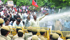 Delhi policemen stop BJP workers during their demonstration against alleged atrocities of task forces in illegal colonies in New Delhi on Thursday.