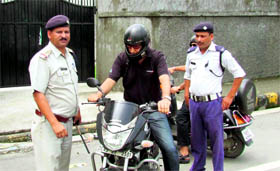 Police personnel tell a parent to leave at a gate of St Josephs Academy in Dehradun on Thursday.