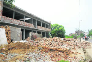 Commercial buildings and residences near Football Chowk, which are being demolished to widen the road, in Jalandhar on Thursday. 