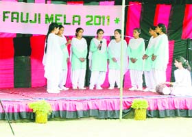 Students sing a song during the Army mela at Mendhar in Poonch district on Thursday