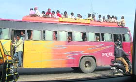 Taking rules for a ride, a private bus carries passengers on the top in Jalandhar
