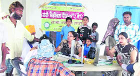 Doctors check patients during a medical camp at Bhatton village on Thursday.