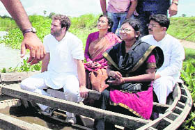 AICC general secretary Rahul Gandhi uses a boat to cross Ami river to visit Katka village in Gorakhpur district on Thursday.