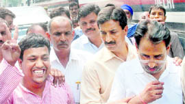 Sanjeev Saxena (extreme right) and Sohail Hindustani (extreme left) are taken away after being produced in Tis Hazari court in New Delhi on Thursday.