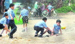 Children enjoy a splash at Sector 10 in Chandigarh on Friday.