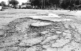 A potholed stretch of the road separating Sectors 4 and 5 in Panchkula. 