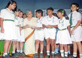 Schoolchildren interact with Gursharan Kaur, the wife of Prime Minister Manmohan Singh, at a function Itihaas Anveshan-2011: Shatak Ko Salaam in New Delhi on Friday