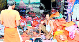 A shopkeeper sells clothes for Kanwariyas in Haridwar.