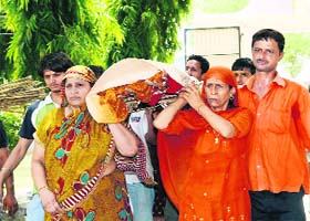 Daughters carry the body of their mother in Sirsa on Friday