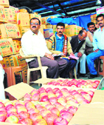 Apple growers sell their produce at Dhalli in Shimla on Friday.