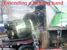 Armymen clean a water filteration plant in Baramulla.