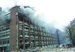 Smoke billows out from a government building after a powerful explosion rocked central Oslo