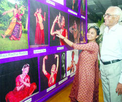 Visitors admire photographs on display at the exhibition at India Habitat Centre in New Delhi
