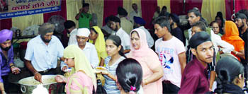 Devotees queue up for langar at Gurdwara Bangla Sahib on the occasion of Guru Harkrishan Sahib Maharaj Parkash Parv in New Delhi 