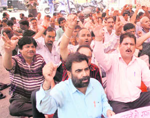 Members of the Bharatiya Mazdoor Sangh stage a protest in Jammu 