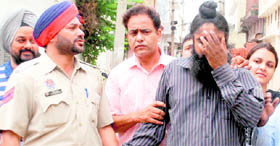 Fake food inspector Gurpreet Singh in police custody in Ludhiana on Saturday.