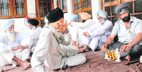 Kin of Major Gurbhej Singh Cheema at his residence at Damulian village in Kapurthala on Saturday.