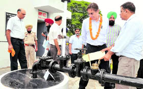 Members of the World Bank team inspect a 24-hr rural water supply system at Singhpura village, Mohali, on Saturday.