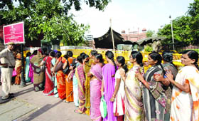 Visitors line up for a security check at the 