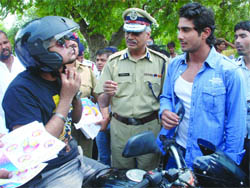 Actor Prateek Babbar along with Satyender Garg, joint-commissioner (traffic) talks to a biker at Rajpath during a traffic awareness drive in New Delhi on Sunday.