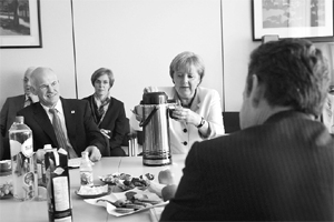 The German Chancellor (centre), The Prime Minister of Greece (left) and the French President (with his back to the camera) at a meeting to bail out Greece from a growing debt crisis. 