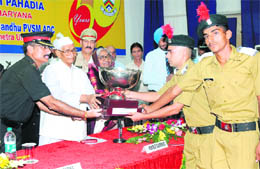 Governor Jagannath Pahadia presents the Cock House trophy to Thanesar House for 2010-11 during the 51st founders day celebrations at Sainik School, Kunjpura (Karnal), on Sunday. 