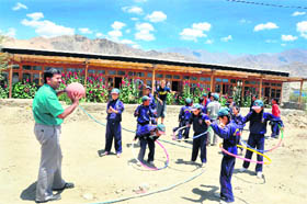 Druk White Lotus School principal Prasad Eledath plays with students. 