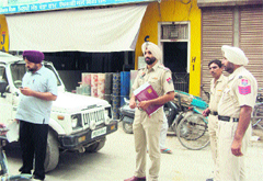 Police officials inspect the crime spot near the Nehru Market, Jagraon, on Saturday. 