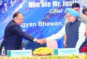 PM Manmohan Singh shakes hands with Chief Justice of India Justice SH Kapadia at a seminar in New Delhi