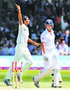 Jonatahan Trott (R) looks at his stumps after being dismissed by Ishant Sharma at Lords on Sunday.