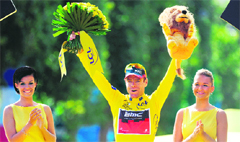 Yellow jersey of overall leader, Australia's Cadel Evans celebrates on the podium after he won the Tour de France race on Sunday. 