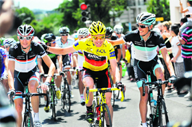 Yellow jersey Australia's Cadel Evans (C), rides with second-placed, Luxembourg's Andy Schleck (R) and his brother Frank Schleck, in the 95 km and last stage of Tour de France on Sunday. 