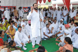 Congress MLA Harminder Singh Jassi addresses a dharna against the proposed solid waste management plant near the residential colonies in Bathinda on Monday