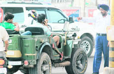 A traffic cop stops a person for using mobile while driving at Zirakpur. 