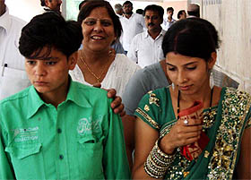 Two girls, who recently got married, come out of a court in Gurgaon after filling a request for police protection for them as the local people are against the alliance.