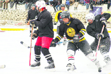 Players play ice-hockey at a temporary rink in Ladakh. 