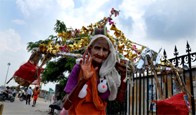  An old woman brings a kavad from Shiv Temple in Gurgaon on Tuesday.