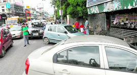 Cars parked outside a school on the main Rajpur Road blocking the flow of traffic in Dehradun.